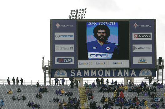 FLORENCE, ITALY - DECEMBER 04: ACF Fiorentina show a giant picture in memory of Socrates during the Serie A match between ACF Fiorentina and AS Roma at Stadio Artemio Franchi on December 4, 2011 in Florence, Italy. (Photo by Marco Luzzani/Getty Images) FLORENCE, ITALY - DECEMBER 04: ACF Fiorentina show a giant picture in memory of Socrates during the Serie A match between ACF Fiorentina and AS Roma at Stadio Artemio Franchi on December 4, 2011 in Florence, Italy. (Photo by Marco Luzzani/Getty Images)