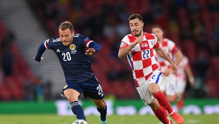 GLASGOW, SCOTLAND - JUNE 22: Ryan Fraser of Scotland runs with the ball as he is closed down by Josip Juranovic of Croatia during the UEFA Euro 2020 Championship Group D match between Croatia and Scotland at Hampden Park on June 22, 2021 in Glasgow, Scotland. (Photo by Stu Forster/Getty Images) 