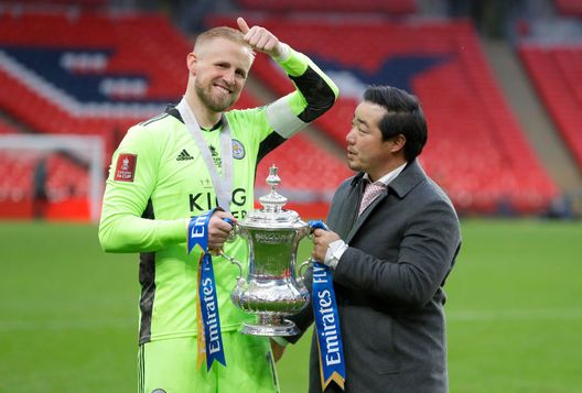 LONDON, ENGLAND - MAY 15: Khun Top, Chairman of Leicester City and Kasper Schmeichel of Leicester City celebrate with the Emirates FA Cup trophy following The Emirates FA Cup Final match between Chelsea and Leicester City at Wembley Stadium on May 15, 2021 in London, England. A limited number of around 21,000 fans, subject to a negative lateral flow test, will be allowed inside Wembley Stadium to watch this year's FA Cup Final as part of a pilot event to trial the return of large crowds to UK venues. (Photo by Kirsty Wigglesworth - Pool/Getty Images) LONDON, ENGLAND - MAY 15: Khun Top, Chairman of Leicester City and Kasper Schmeichel of Leicester City celebrate with the Emirates FA Cup trophy following The Emirates FA Cup Final match between Chelsea and Leicester City at Wembley Stadium on May 15, 2021 in London, England. A limited number of around 21,000 fans, subject to a negative lateral flow test, will be allowed inside Wembley Stadium to watch this year's FA Cup Final as part of a pilot event to trial the return of large crowds to UK venues. (Photo by Kirsty Wigglesworth - Pool/Getty Images)