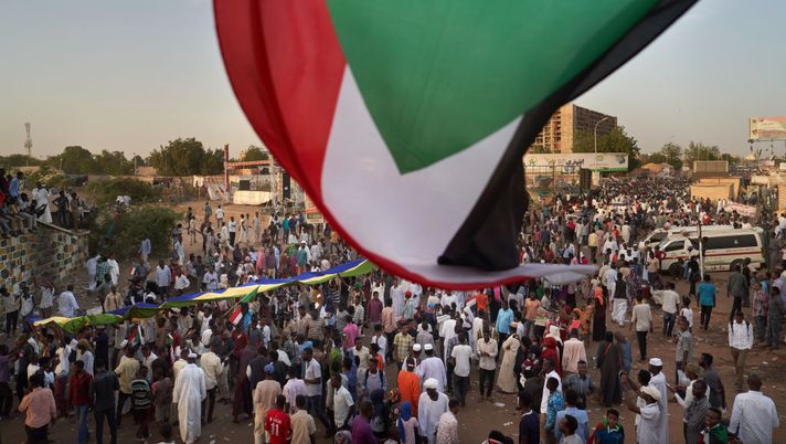 KHARTOUM, SUDAN - MAY 03: A flag is waved over the protest on May 03, 2019 in Khartoum, Sudan. Thousands of demonstrators continued their mass sit-in outside military headquarters in Khartoum to call on the country's military rulers to cede control. (Photo by David Degner/Getty Images) KHARTOUM, SUDAN - MAY 03: A flag is waved over the protest on May 03, 2019 in Khartoum, Sudan. Thousands of demonstrators continued their mass sit-in outside military headquarters in Khartoum to call on the country's military rulers to cede control. (Photo by David Degner/Getty Images)