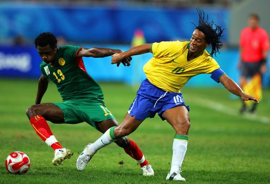  SHENYANG, CHINA - AUGUST 16: Ronaldinho (R) of Brazil and Nicolas Nkoulou of Cameroon compete for the ball during the Men's Quarter Final match between Brazil and Cameroon at Shenyang Olympic Stadium on Day 8 of the Beijing 2008 Olympic Games on August 16, 2008 in Shenyang, China. (Photo by Koji Watanabe/Getty Images) 