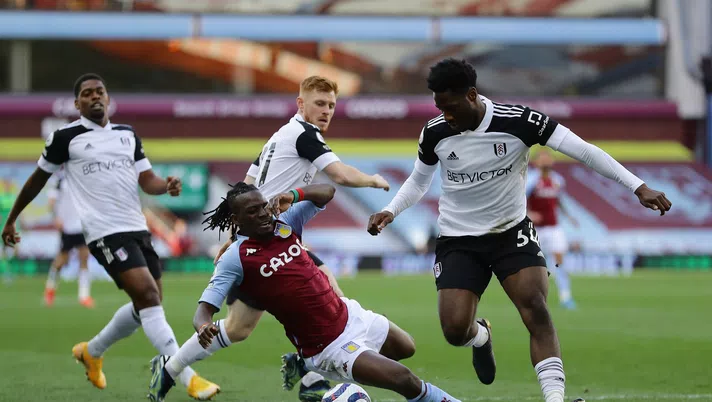 BIRMINGHAM, ENGLAND - APRIL 04: Bertrand Traore of Aston Villa goes down in a challenge from Ola Aina of Fulham during the Premier League match between Aston Villa and Fulham at Villa Park on April 04, 2021 in Birmingham, England. Sporting stadiums around the UK remain under strict restrictions due to the Coronavirus Pandemic as Government social distancing laws prohibit fans inside venues resulting in games being played behind closed doors. (Photo by Richard Heathcote/Getty Images)