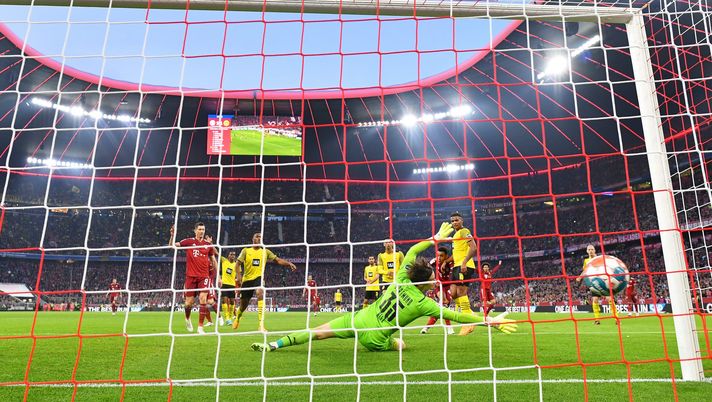 MUNICH, GERMANY - APRIL 23: Jamal Musiala of FC Bayern Muenchen scores their team's third goal past Marwin Hitz of Borussia Dortmund during the Bundesliga match between FC Bayern Muenchen and Borussia Dortmund at Allianz Arena on April 23, 2022 in Munich, Germany. (Photo by Stuart Franklin/Getty Images) MUNICH, GERMANY - APRIL 23: Jamal Musiala of FC Bayern Muenchen scores their team's third goal past Marwin Hitz of Borussia Dortmund during the Bundesliga match between FC Bayern Muenchen and Borussia Dortmund at Allianz Arena on April 23, 2022 in Munich, Germany. (Photo by Stuart Franklin/Getty Images)