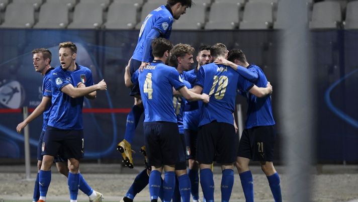 CELJE, SLOVENIA - MARCH 30: Giulio Maggiore (Hidden) of Italy celebrates with team mates after scoring their side's first goal during the 2021 UEFA European Under-21 Championship Group B match between Italy and Slovenia at Stadion Celje on March 30, 2021 in Celje, Slovenia. Sporting stadiums around Slovenia remain under strict restrictions due to the Coronavirus Pandemic as Government social distancing laws prohibit fans inside venues resulting in games being played behind closed doors. (Photo by Jurij Kodrun/Getty Images) CELJE, SLOVENIA - MARCH 30: Giulio Maggiore (Hidden) of Italy celebrates with team mates after scoring their side's first goal during the 2021 UEFA European Under-21 Championship Group B match between Italy and Slovenia at Stadion Celje on March 30, 2021 in Celje, Slovenia. Sporting stadiums around Slovenia remain under strict restrictions due to the Coronavirus Pandemic as Government social distancing laws prohibit fans inside venues resulting in games being played behind closed doors. (Photo by Jurij Kodrun/Getty Images)