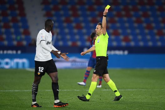 VALENCIA, SPAIN - MARCH 12: Mouctar Diakhaby of Valencia is booked by referee, Guillermo Cuadra Fernandez during the La Liga Santander match between Levante UD and Valencia CF at Ciutat de Valencia Stadium on March 12, 2021 in Valencia, Spain. Sporting stadiums around Spain remain under strict restrictions due to the Coronavirus Pandemic as Government social distancing laws prohibit fans inside venues resulting in games being played behind closed doors. (Photo by Alex Caparros/Getty Images) VALENCIA, SPAIN - MARCH 12: Mouctar Diakhaby of Valencia is booked by referee, Guillermo Cuadra Fernandez during the La Liga Santander match between Levante UD and Valencia CF at Ciutat de Valencia Stadium on March 12, 2021 in Valencia, Spain. Sporting stadiums around Spain remain under strict restrictions due to the Coronavirus Pandemic as Government social distancing laws prohibit fans inside venues resulting in games being played behind closed doors. (Photo by Alex Caparros/Getty Images)