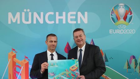MUNICH, GERMANY - OCTOBER 27:  DFB president Reinhard Grindel (R) receives a present by UEFA president Aleksander Ceferin after the official EURO 2020 logo presentation for the Munich venue on October 27, 2016 in Munich, Germany. EURO 2020 will be played in 13 venues all over Europe and the Munich Allianz Arena stadium will be the venue in Germany.  (Photo by Alexandra Beier/Bongarts/Getty Images)