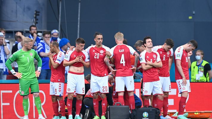 COPENHAGEN, DENMARK - JUNE 12: Joakim Maehle, Yussuf Poulsen, Simon Kjaer and Thomas Delaney of Denmark look dejected as team mate Christian Eriksen (hidden) receives medical treatment during the UEFA Euro 2020 Championship Group B match between Denmark and Finland on June 12, 2021 in Copenhagen, Denmark. (Photo by Stuart Franklin/Getty Images) COPENHAGEN, DENMARK - JUNE 12: Joakim Maehle, Yussuf Poulsen, Simon Kjaer and Thomas Delaney of Denmark look dejected as team mate Christian Eriksen (hidden) receives medical treatment during the UEFA Euro 2020 Championship Group B match between Denmark and Finland on June 12, 2021 in Copenhagen, Denmark. (Photo by Stuart Franklin/Getty Images)