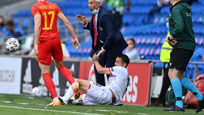 CARDIFF, WALES - JUNE 05: Edoardo Reja, Head Coach of Albania is knocked over on the sidelines by Rey Manaj of Albania during the International Friendly match between Wales and Albania at Cardiff City Stadium on June 05, 2021 in Cardiff, Wales. (Photo by Justin Setterfield/Getty Images) 