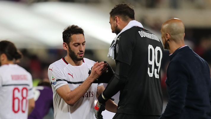 FLORENCE, ITALY - MAY 11: Hakan Calhanoglu and Gianluigi Donnarumma of AC Milan celebrates the victory after the Serie A match between ACF Fiorentina and AC Milan at Stadio Artemio Franchi on May 11, 2019 in Florence, Italy. (Photo by Gabriele Maltinti/Getty Images) FLORENCE, ITALY - MAY 11: Hakan Calhanoglu and Gianluigi Donnarumma of AC Milan celebrates the victory after the Serie A match between ACF Fiorentina and AC Milan at Stadio Artemio Franchi on May 11, 2019 in Florence, Italy. (Photo by Gabriele Maltinti/Getty Images)