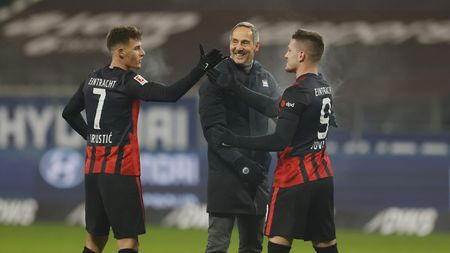 FRANKFURT AM MAIN, GERMANY - JANUARY 17: Adi Hutter, head coach of Eintracht Frankfurt celebrates victory with (L - R) Ajdin Hrustic and Bas Dost of Eintracht Frankfurt following the Bundesliga match between Eintracht Frankfurt and FC Schalke 04 at Deutsche Bank Park on January 17, 2021 in Frankfurt am Main, Germany. Sporting stadiums around Germany remain under strict restrictions due to the Coronavirus Pandemic as Government social distancing laws prohibit fans inside venues resulting in games being played behind closed doors. (Photo by Ronald Wittek - Pool/Getty Images)