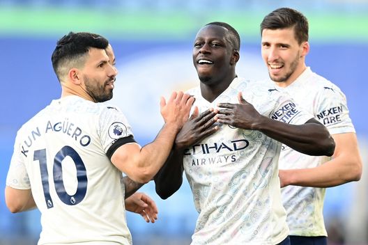 LEICESTER, ENGLAND - APRIL 03: Benjamin Mendy of Manchester City celebrates with teammate Sergio Aguero after scoring their team's first goal during the Premier League match between Leicester City and Manchester City at The King Power Stadium on April 03, 2021 in Leicester, England. Sporting stadiums around the UK remain under strict restrictions due to the Coronavirus Pandemic as Government social distancing laws prohibit fans inside venues resulting in games being played behind closed doors. (Photo by Michael Regan/Getty Images) LEICESTER, ENGLAND - APRIL 03: Benjamin Mendy of Manchester City celebrates with teammate Sergio Aguero after scoring their team's first goal during the Premier League match between Leicester City and Manchester City at The King Power Stadium on April 03, 2021 in Leicester, England. Sporting stadiums around the UK remain under strict restrictions due to the Coronavirus Pandemic as Government social distancing laws prohibit fans inside venues resulting in games being played behind closed doors. (Photo by Michael Regan/Getty Images)