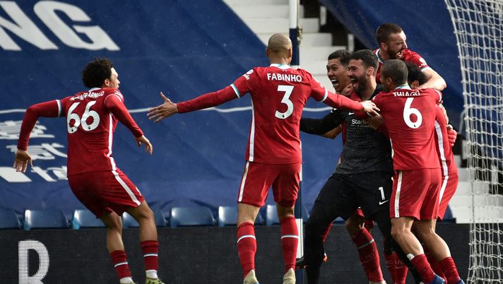 WEST BROMWICH, ENGLAND - MAY 16: Alisson of Liverpool celebrates with team mates after scoring their side's second goal during the Premier League match between West Bromwich Albion and Liverpool at The Hawthorns on May 16, 2021 in West Bromwich, England. Sporting stadiums around the UK remain under strict restrictions due to the Coronavirus Pandemic as Government social distancing laws prohibit fans inside venues resulting in games being played behind closed doors. (Photo by Rui Vieira - Pool/Getty Images) WEST BROMWICH, ENGLAND - MAY 16: Alisson of Liverpool celebrates with team mates after scoring their side's second goal during the Premier League match between West Bromwich Albion and Liverpool at The Hawthorns on May 16, 2021 in West Bromwich, England. Sporting stadiums around the UK remain under strict restrictions due to the Coronavirus Pandemic as Government social distancing laws prohibit fans inside venues resulting in games being played behind closed doors. (Photo by Rui Vieira - Pool/Getty Images)