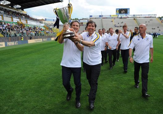 PARMA, ITALY - MAY 12: Alberto Di Chiara (L) and Alessandro Melli celebrate with the cup the twentieth anniversary of the conquest of the Cup Winner's Cup at Wembley prior to the Serie A match between Parma FC and Bologna FC at Stadio Ennio Tardini on May 12, 2013 in Parma, Italy. (Photo by Valerio Pennicino/Getty Images)