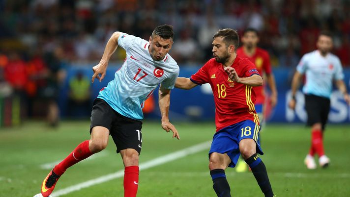 NICE, FRANCE - JUNE 17:  Burak Yilmaz of Turkey and Jordi Alba of Spain battle for possesion during the UEFA EURO 2016 Group D match between Spain and Turkey at Allianz Riviera Stadium on June 17, 2016 in Nice, France.  (Photo by Alex Livesey/Getty Images) 