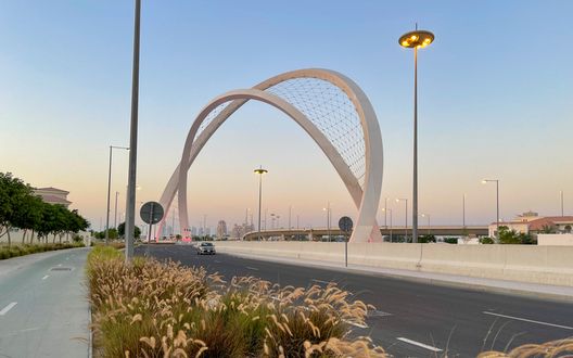 Doha, Qatar - March 26, 2020: Al Wahda Bridge The Tallest Monument of City. known as 56 Bridge of Arch Doha, Qatar - March 26, 2020: Al Wahda Bridge The Tallest Monument of City. known as 56 Bridge of Arch