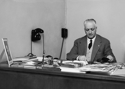 Italian car manufacturer Enzo Ferrari (1898 - 1988) at his desk, circa 1955. (Photo by Keystone/Hulton Archive/Getty Images) Italian car manufacturer Enzo Ferrari (1898 - 1988) at his desk, circa 1955. (Photo by Keystone/Hulton Archive/Getty Images)