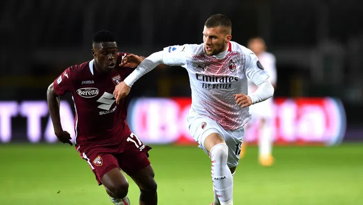 TURIN, ITALY - MAY 12: Ante Rebic of A.C. Milan battles for possession with Wilfried Singo of Torino FC during the Serie A match between Torino FC  and AC Milan at Stadio Olimpico di Torino on May 12, 2021 in Turin, Italy. Sporting stadiums around Italy remain under strict restrictions due to the Coronavirus Pandemic as Government social distancing laws prohibit fans inside venues resulting in games being played behind closed doors. (Photo by Valerio Pennicino/Getty Images)