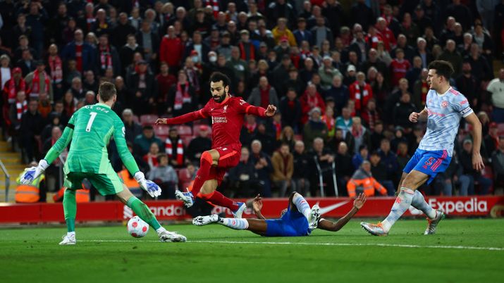 LIVERPOOL, ENGLAND - APRIL 19: Mohamed Salah of Liverpool has a shot on goal whilst under pressure from Aaron Wan-Bissaka and Harry Maguire of Manchester United during the Premier League match between Liverpool and Manchester United at Anfield on April 19, 2022 in Liverpool, England. (Photo by Clive Brunskill/Getty Images) LIVERPOOL, ENGLAND - APRIL 19: Mohamed Salah of Liverpool has a shot on goal whilst under pressure from Aaron Wan-Bissaka and Harry Maguire of Manchester United during the Premier League match between Liverpool and Manchester United at Anfield on April 19, 2022 in Liverpool, England. (Photo by Clive Brunskill/Getty Images)