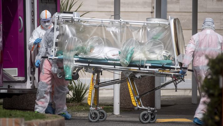 ROME, ITALY - MARCH 17: Medical staff collect a patient from an ambulance at the second Covid-19 hospital in the Columbus unit on March 17, 2020, in Rome, Italy. Italian Government continues to enfoce the nationwide lockdown measures to control the coronavirus spread. (Photo by Antonio Masiello/Getty Images) ROME, ITALY - MARCH 17: Medical staff collect a patient from an ambulance at the second Covid-19 hospital in the Columbus unit on March 17, 2020, in Rome, Italy. Italian Government continues to enfoce the nationwide lockdown measures to control the coronavirus spread. (Photo by Antonio Masiello/Getty Images)
