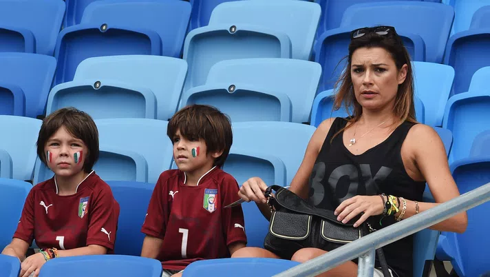 NATAL, BRAZIL - JUNE 24:  Alena Seredova, wife of Gianluigi Buffon of Italy, looks on looks on with their sons David and Louis ahead of the 2014 FIFA World Cup Brazil Group D match between Italy and Uruguay at Estadio das Dunas on June 24, 2014 in Natal, Brazil.  (Photo by Claudio Villa/Getty Images)