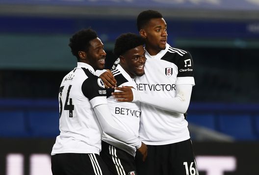 LIVERPOOL, ENGLAND - FEBRUARY 14: Josh Maja of Fulham celebrates with team mates Ola Aina and Tosin Adarabioyo after scoring their side's second goal during the Premier League match between Everton and Fulham at Goodison Park on February 14, 2021 in Liverpool, England. Sporting stadiums around the UK remain under strict restrictions due to the Coronavirus Pandemic as Government social distancing laws prohibit fans inside venues resulting in games being played behind closed doors. (Photo by Jason Cairnduff - Pool/Getty Images) LIVERPOOL, ENGLAND - FEBRUARY 14: Josh Maja of Fulham celebrates with team mates Ola Aina and Tosin Adarabioyo after scoring their side's second goal during the Premier League match between Everton and Fulham at Goodison Park on February 14, 2021 in Liverpool, England. Sporting stadiums around the UK remain under strict restrictions due to the Coronavirus Pandemic as Government social distancing laws prohibit fans inside venues resulting in games being played behind closed doors. (Photo by Jason Cairnduff - Pool/Getty Images)