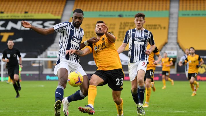 WOLVERHAMPTON, ENGLAND - JANUARY 16: Semi Ajayi of West Bromwich Albion is challenged by Patrick Cutrone of Wolverhampton Wanderers during the Premier League match between Wolverhampton Wanderers and West Bromwich Albion at Molineux on January 16, 2021 in Wolverhampton, England. Sporting stadiums around England remain under strict restrictions due to the Coronavirus Pandemic as Government social distancing laws prohibit fans inside venues resulting in games being played behind closed doors. (Photo by Shaun Botterill/Getty Images) 