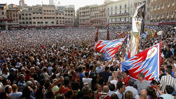 SIENA, ITALY - JULY 2: Winners of the "Palio di Siena" from the Panter district celebrate their victory at the Piazza del Campo on July 2, 2006 in Siena, Italy. The annual horse race and pageant which began in the 11th century to pay homage to the Madonna, pits the 17 ancient districts or "contrades" of Siena against each other for the victory banner. (Photo by Franco Origlia/Getty Images) SIENA, ITALY - JULY 2: Winners of the "Palio di Siena" from the Panter district celebrate their victory at the Piazza del Campo on July 2, 2006 in Siena, Italy. The annual horse race and pageant which began in the 11th century to pay homage to the Madonna, pits the 17 ancient districts or "contrades" of Siena against each other for the victory banner. (Photo by Franco Origlia/Getty Images)