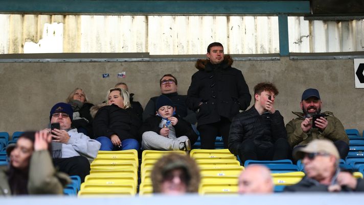 LONDON, ENGLAND - DECEMBER 05: Millwall fans sitting in the stands before the Sky Bet Championship match between Millwall and Derby County at The Den on December 05, 2020 in London, England. A limited number of fans are welcomed back to stadiums to watch elite football across England. This was following easing of restrictions on spectators in tiers one and two areas only. (Photo by Jacques Feeney/Getty Images) LONDON, ENGLAND - DECEMBER 05: Millwall fans sitting in the stands before the Sky Bet Championship match between Millwall and Derby County at The Den on December 05, 2020 in London, England. A limited number of fans are welcomed back to stadiums to watch elite football across England. This was following easing of restrictions on spectators in tiers one and two areas only. (Photo by Jacques Feeney/Getty Images)