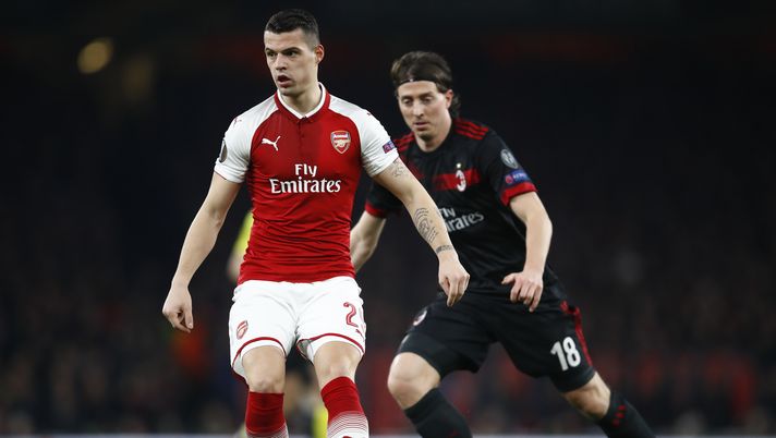 LONDON, ENGLAND - MARCH 15: Granit Xhaka of Arsenal keeps the ball from Riccardo Montolivo of AC Milan during the UEFA Europa League Round of 16 Second Leg match between Arsenal and AC Milan at Emirates Stadium on March 15, 2018 in London, England. (Photo by Julian Finney/Getty Images) LONDON, ENGLAND - MARCH 15: Granit Xhaka of Arsenal keeps the ball from Riccardo Montolivo of AC Milan during the UEFA Europa League Round of 16 Second Leg match between Arsenal and AC Milan at Emirates Stadium on March 15, 2018 in London, England. (Photo by Julian Finney/Getty Images)