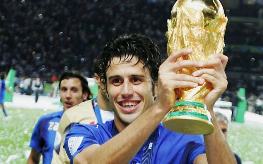 BERLIN - JULY 09: Fabio Grosso of Italy holds the World Cup trophy aloft following his team's victory in a penalty shootout at the end of the FIFA World Cup Germany 2006 Final match between Italy and France at the Olympic Stadium on July 9, 2006 in Berlin, Germany. (Photo by Alex Livesey/Getty Images) BERLIN - JULY 09: Fabio Grosso of Italy holds the World Cup trophy aloft following his team's victory in a penalty shootout at the end of the FIFA World Cup Germany 2006 Final match between Italy and France at the Olympic Stadium on July 9, 2006 in Berlin, Germany. (Photo by Alex Livesey/Getty Images)