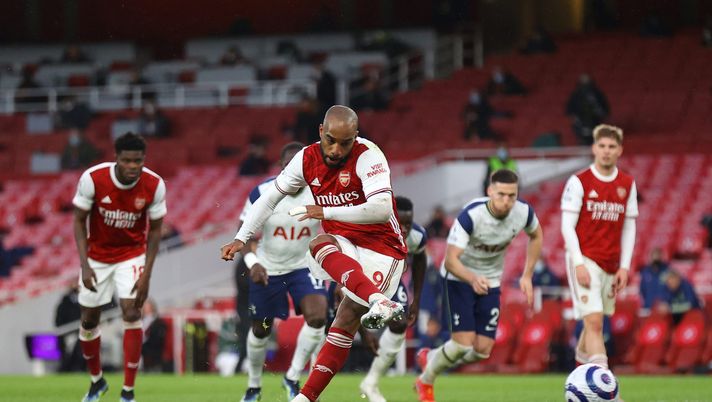 LONDON, ENGLAND - MARCH 14: Alexandre Lacazette of Arsenal scores their side's second goal from the penalty spot during the Premier League match between Arsenal and Tottenham Hotspur at Emirates Stadium on March 14, 2021 in London, England. Sporting stadiums around the UK remain under strict restrictions due to the Coronavirus Pandemic as Government social distancing laws prohibit fans inside venues resulting in games being played behind closed doors. (Photo by Julian Finney/Getty Images) LONDON, ENGLAND - MARCH 14: Alexandre Lacazette of Arsenal scores their side's second goal from the penalty spot during the Premier League match between Arsenal and Tottenham Hotspur at Emirates Stadium on March 14, 2021 in London, England. Sporting stadiums around the UK remain under strict restrictions due to the Coronavirus Pandemic as Government social distancing laws prohibit fans inside venues resulting in games being played behind closed doors. (Photo by Julian Finney/Getty Images)