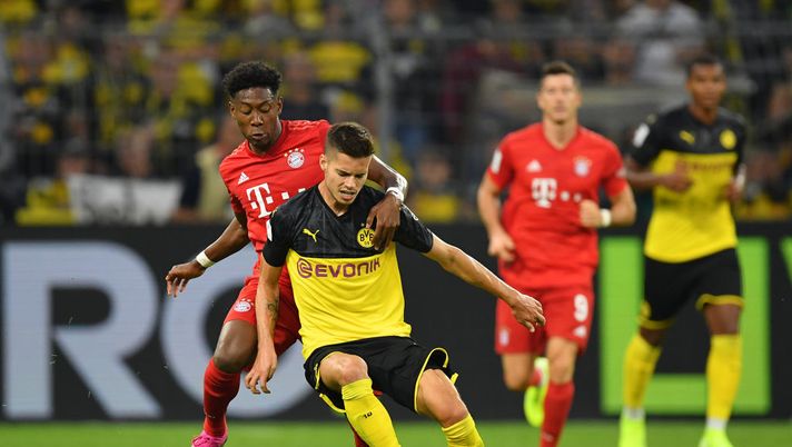 DORTMUND, GERMANY - AUGUST 03: David Alaba of Muenchen is challenged by Julian Weigl of Dortmund during the DFL Supercup 2019 match between Borussia Dortmund and FC Bayern München at Signal Iduna Park on August 03, 2019 in Dortmund, Germany. (Photo by Stuart Franklin/Bongarts/Getty Images) DORTMUND, GERMANY - AUGUST 03: David Alaba of Muenchen is challenged by Julian Weigl of Dortmund during the DFL Supercup 2019 match between Borussia Dortmund and FC Bayern München at Signal Iduna Park on August 03, 2019 in Dortmund, Germany. (Photo by Stuart Franklin/Bongarts/Getty Images)