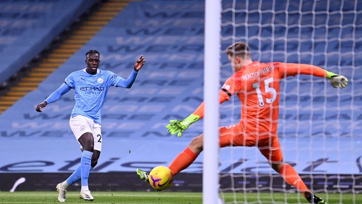 MANCHESTER, ENGLAND - NOVEMBER 28: Benjamin Mendy of Manchester City scores their team's third goal past Bailey Peacock-Farrell of Burnley during the Premier League match between Manchester City and Burnley at Etihad Stadium on November 28, 2020 in Manchester, England. Sporting stadiums around the UK remain under strict restrictions due to the Coronavirus Pandemic as Government social distancing laws prohibit fans inside venues resulting in games being played behind closed doors. (Photo by Laurence Griffiths/Getty Images) MANCHESTER, ENGLAND - NOVEMBER 28: Benjamin Mendy of Manchester City scores their team's third goal past Bailey Peacock-Farrell of Burnley during the Premier League match between Manchester City and Burnley at Etihad Stadium on November 28, 2020 in Manchester, England. Sporting stadiums around the UK remain under strict restrictions due to the Coronavirus Pandemic as Government social distancing laws prohibit fans inside venues resulting in games being played behind closed doors. (Photo by Laurence Griffiths/Getty Images)