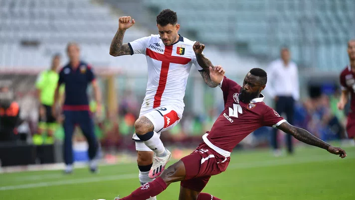 TURIN, ITALY - JULY 16:  Nicolas Nkoulou (R) of Torino FC tackles Andrea Pinamonti of Genoa CFC during the Serie A match between Torino FC and  Genoa CFC at Stadio Olimpico di Torino on July 16, 2020 in Turin, Italy.  (Photo by Valerio Pennicino/Getty Images)
