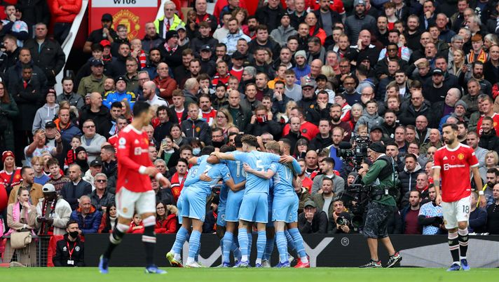 MANCHESTER, ENGLAND - NOVEMBER 06: Manchester City players celebrate after an own goal by Eric Bailly of Manchester United (not pictured) during the Premier League match between Manchester United and Manchester City at Old Trafford on November 06, 2021 in Manchester, England. (Photo by Clive Brunskill/Getty Images) MANCHESTER, ENGLAND - NOVEMBER 06: Manchester City players celebrate after an own goal by Eric Bailly of Manchester United (not pictured) during the Premier League match between Manchester United and Manchester City at Old Trafford on November 06, 2021 in Manchester, England. (Photo by Clive Brunskill/Getty Images)