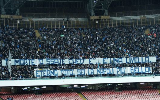 NAPLES, ITALY - APRIL 15: Supporters of SSC Napoli show a banner for the 50th anniversary of the death of Totò during the Serie A match between SSC Napoli and Udinese Calcio at Stadio San Paolo on April 15, 2017 in Naples, Italy. (Photo by Francesco Pecoraro/Getty Images) NAPLES, ITALY - APRIL 15: Supporters of SSC Napoli show a banner for the 50th anniversary of the death of Totò during the Serie A match between SSC Napoli and Udinese Calcio at Stadio San Paolo on April 15, 2017 in Naples, Italy. (Photo by Francesco Pecoraro/Getty Images)