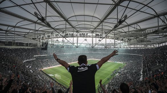 TOPSHOT - Supporters of Besiktas football club cheer on their team before the start of the Turkish Spor Toto Super league football match between Besiktas and Bursaspor at vodafone arena stadium on April 11, 2016 in Istanbul.Besiktas football team play its first game at their new vodafone Arena stadium since its inauguration on April 10. / AFP / OZAN KOSE (Photo credit should read OZAN KOSE/AFP/Getty Images) TOPSHOT - Supporters of Besiktas football club cheer on their team before the start of the Turkish Spor Toto Super league football match between Besiktas and Bursaspor at vodafone arena stadium on April 11, 2016 in Istanbul.Besiktas football team play its first game at their new vodafone Arena stadium since its inauguration on April 10. / AFP / OZAN KOSE (Photo credit should read OZAN KOSE/AFP/Getty Images)