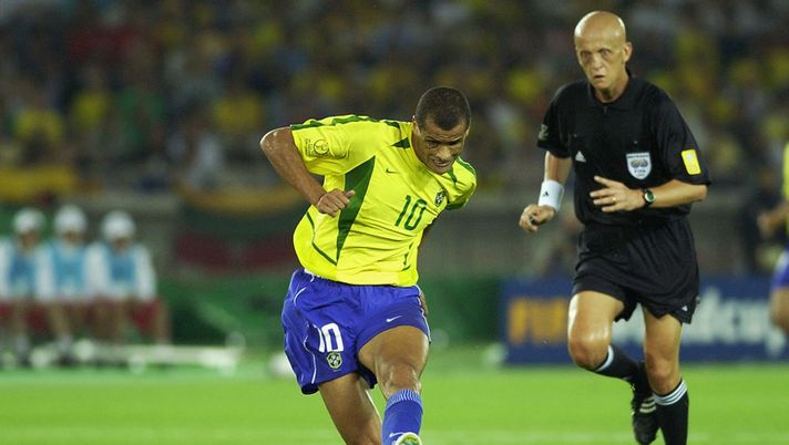 YOKOHAMA - JUNE 30:  Rivaldo of Brazil is watched by referee Pierluigi Collina during the Germany v Brazil, World Cup Final match played at the International Stadium Yokohama, Yokohama, Japan on June 30, 2002. Brazil won 2-0. (Photo by Gary M. Prior/Getty Images) 