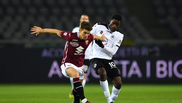 TURIN, ITALY - JANUARY 16: Jacopo Segre of Torino is challenged by Lucien Agoume of Spezia during the Serie A match between Torino FC and Spezia Calcio at Stadio Olimpico di Torino on January 16, 2021 in Turin, Italy. Sporting stadiums around Italy remain under strict restrictions due to the Coronavirus Pandemic as Government social distancing laws prohibit fans inside venues resulting in games being played behind closed doors. (Photo by Valerio Pennicino/Getty Images) segre