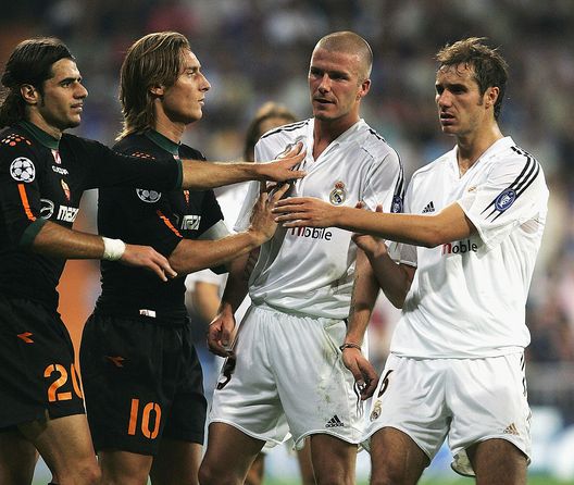 MADRID, SPAIN - SEPTEMBER 28: David Beckham of Real Madrid is held back by team-mate Ivan Helguera and Simone Perrotta and Francesco Totti of Roma during the UEFA Champions League Group B match between Real Madrid and Roma at the Santiago Bernabeu Stadium on September 28, 2004 in Madrid, Spain. (Photo by Shaun Botterill/Getty Images) MADRID, SPAIN - SEPTEMBER 28: David Beckham of Real Madrid is held back by team-mate Ivan Helguera and Simone Perrotta and Francesco Totti of Roma during the UEFA Champions League Group B match between Real Madrid and Roma at the Santiago Bernabeu Stadium on September 28, 2004 in Madrid, Spain. (Photo by Shaun Botterill/Getty Images)