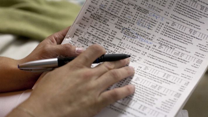 BOSTON - AUGUST 20: Jackie Davis analyzes the statistics of her competitors and their horses in order to determine a strategy for her races. (Photo by Tamir Kalifa for The Boston Globe via Getty Images) 
