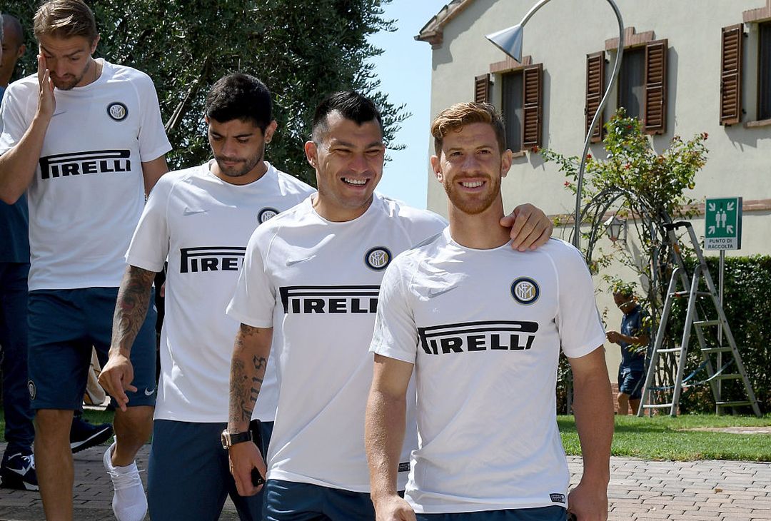  JESI, ITALY - AUGUST 10:  Gary Medel and Cristian Ansaldi (R) chat during the walk around the hotel on August 10, 2016 in Jesi, Italy.  (Photo by Claudio Villa - Inter/Inter via Getty Images)  