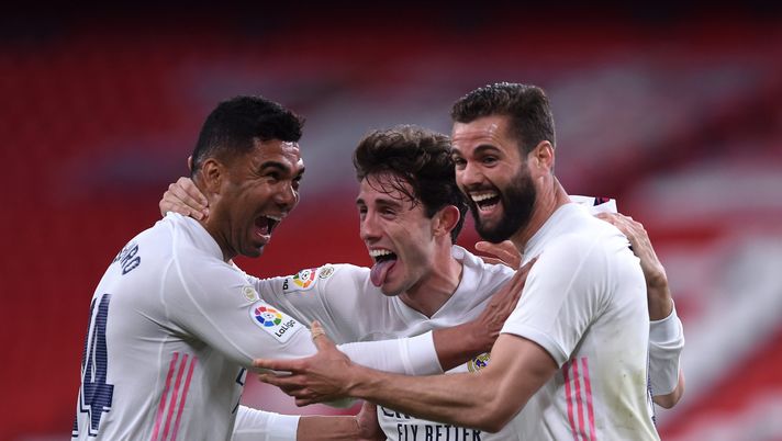 BILBAO, SPAIN - MAY 16: Nacho of Real Madrid celebrates with team mates (L - R) Casemiro and Alvaro Odriozola after scoring their side's first goal during the La Liga Santander match between Athletic Club and Real Madrid at Estadio de San Mames on May 16, 2021 in Bilbao, Spain. Sporting stadiums around Spain remain under strict restrictions due to the Coronavirus Pandemic as Government social distancing laws prohibit fans inside venues resulting in games being played behind closed doors. (Photo by Juan Manuel Serrano Arce/Getty Images) BILBAO, SPAIN - MAY 16: Nacho of Real Madrid celebrates with team mates (L - R) Casemiro and Alvaro Odriozola after scoring their side's first goal during the La Liga Santander match between Athletic Club and Real Madrid at Estadio de San Mames on May 16, 2021 in Bilbao, Spain. Sporting stadiums around Spain remain under strict restrictions due to the Coronavirus Pandemic as Government social distancing laws prohibit fans inside venues resulting in games being played behind closed doors. (Photo by Juan Manuel Serrano Arce/Getty Images)