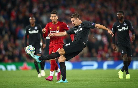 LIVERPOOL, ENGLAND - OCTOBER 02: Maximilian Wober of FC Salzburg clears the ball from Roberto Firmino of Liverpool during the UEFA Champions League group E match between Liverpool FC and RB Salzburg at Anfield on October 02, 2019 in Liverpool, United Kingdom. (Photo by Clive Brunskill/Getty Images) LIVERPOOL, ENGLAND - OCTOBER 02: Maximilian Wober of FC Salzburg clears the ball from Roberto Firmino of Liverpool during the UEFA Champions League group E match between Liverpool FC and RB Salzburg at Anfield on October 02, 2019 in Liverpool, United Kingdom. (Photo by Clive Brunskill/Getty Images)