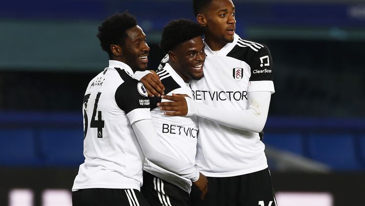 LIVERPOOL, ENGLAND - FEBRUARY 14: Josh Maja of Fulham celebrates with team mates Ola Aina and Tosin Adarabioyo after scoring their side's second goal during the Premier League match between Everton and Fulham at Goodison Park on February 14, 2021 in Liverpool, England. Sporting stadiums around the UK remain under strict restrictions due to the Coronavirus Pandemic as Government social distancing laws prohibit fans inside venues resulting in games being played behind closed doors. (Photo by Jason Cairnduff - Pool/Getty Images) LIVERPOOL, ENGLAND - FEBRUARY 14: Josh Maja of Fulham celebrates with team mates Ola Aina and Tosin Adarabioyo after scoring their side's second goal during the Premier League match between Everton and Fulham at Goodison Park on February 14, 2021 in Liverpool, England. Sporting stadiums around the UK remain under strict restrictions due to the Coronavirus Pandemic as Government social distancing laws prohibit fans inside venues resulting in games being played behind closed doors. (Photo by Jason Cairnduff - Pool/Getty Images)