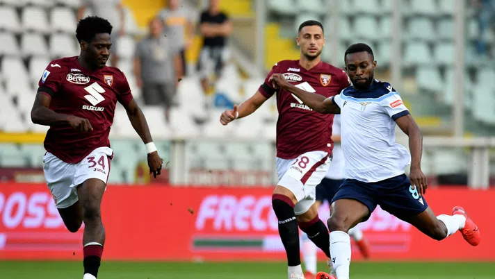 TURIN, ITALY - SEPTEMBER 23: Daniel Akpa Akro of SS Lazio competes for the ball with Ola Aina of Torino FC during the Serie A match between Torino FC v SS Lazio at Stadio Olimpico di Torino on September 23, 2021 in Turin, Italy. (Photo by Marco Rosi - SS Lazio/Getty Images)