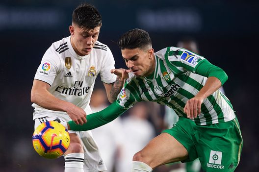 SEVILLE, SPAIN - JANUARY 13: Cristo Ramon Gonzalez of Real Madrid CF (L) competes for the ball with Marc Bartra of Real Betis Balompie (R) during the La Liga match between Real Betis Balompie and Real Madrid CF at Estadio Benito Villamarin on January 13, 2019 in Seville, Spain. (Photo by Aitor Alcalde/Getty Images) SEVILLE, SPAIN - JANUARY 13: Cristo Ramon Gonzalez of Real Madrid CF (L) competes for the ball with Marc Bartra of Real Betis Balompie (R) during the La Liga match between Real Betis Balompie and Real Madrid CF at Estadio Benito Villamarin on January 13, 2019 in Seville, Spain. (Photo by Aitor Alcalde/Getty Images)