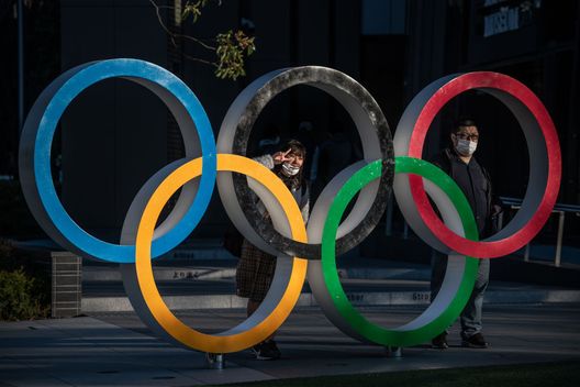 TOKYO, JAPAN - MARCH 24: People wearing face masks pose for photographs next to Olympic Rings on March 24, 2020 in Tokyo, Japan. Although an official decision is yet to be announced, International Olympic Committee member Dick Pound has said the Tokyo 2020 Olympic Games will be postponed by one year because of the Covid-19 coronavirus after the chairman of the British Olympic Association said Great Britain would be unlikely to send a team to Tokyo this summer while Australia and Canada also said they will not compete as the global Covid-19 coronavirus pandemic that has so far seen over 380,000 infections around the world forces countries to take drastic measures to protect their populations. (Photo by Carl Court/Getty Images) TOKYO, JAPAN - MARCH 24: People wearing face masks pose for photographs next to Olympic Rings on March 24, 2020 in Tokyo, Japan. Although an official decision is yet to be announced, International Olympic Committee member Dick Pound has said the Tokyo 2020 Olympic Games will be postponed by one year because of the Covid-19 coronavirus after the chairman of the British Olympic Association said Great Britain would be unlikely to send a team to Tokyo this summer while Australia and Canada also said they will not compete as the global Covid-19 coronavirus pandemic that has so far seen over 380,000 infections around the world forces countries to take drastic measures to protect their populations. (Photo by Carl Court/Getty Images)