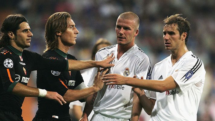 MADRID, SPAIN - SEPTEMBER 28: David Beckham of Real Madrid is held back by team-mate Ivan Helguera and Simone Perrotta and Francesco Totti of Roma during the UEFA Champions League Group B match between Real Madrid and Roma at the Santiago Bernabeu Stadium on September 28, 2004 in Madrid, Spain. (Photo by Shaun Botterill/Getty Images) MADRID, SPAIN - SEPTEMBER 28: David Beckham of Real Madrid is held back by team-mate Ivan Helguera and Simone Perrotta and Francesco Totti of Roma during the UEFA Champions League Group B match between Real Madrid and Roma at the Santiago Bernabeu Stadium on September 28, 2004 in Madrid, Spain. (Photo by Shaun Botterill/Getty Images)