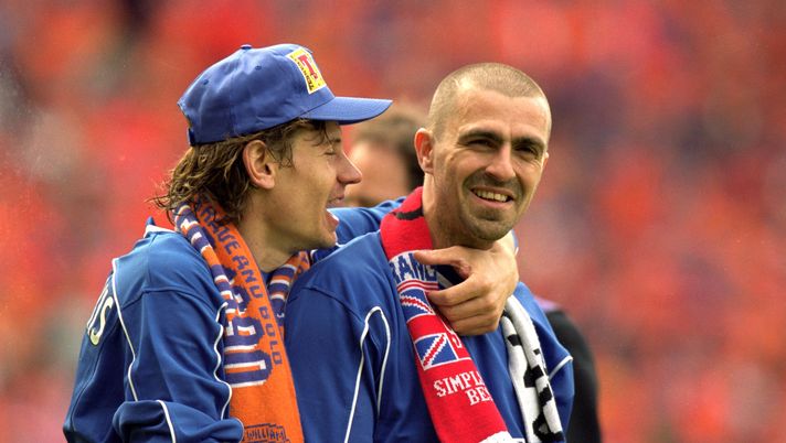 27 May 2000: Rangers players Andrei Kanchelskis with hat on and Sergio Porrini celebrate beating Aberdeen after the Scottish Cup Final at Hampden Park, Scotland. Rangers won 4-0. Mandatory Credit: Jamie McDonald /Allsport 27 May 2000: Rangers players Andrei Kanchelskis with hat on and Sergio Porrini celebrate beating Aberdeen after the Scottish Cup Final at Hampden Park, Scotland. Rangers won 4-0. Mandatory Credit: Jamie McDonald /Allsport